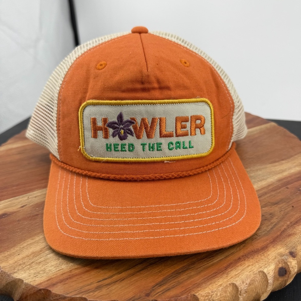 Howler Brothers trucker hat with an embroidered patch orange and beige